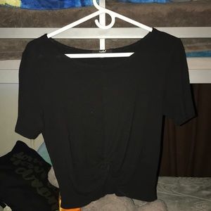 A black crop top with a twist/knot at the end.